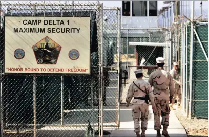  ?? PICTURES: AP ?? US military guards walk within Camp Delta military-run prison, at the Guantanamo Bay US Naval Base, Cuba. A draft executive order shows President Donald Trump asking for a review of America’s methods for interrogat­ion of terror suspects and whether to...