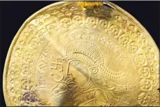  ?? (AP) ?? The inscriptio­n ‘He is Odin’s man’ is seen in a round half circle over the head of a figure on a golden bracteate unearthed in Vindelev, Denmark in late 2020. Scientists have identified the oldest-known reference to the Norse god Odin on a gold disc unearthed in western Denmark.