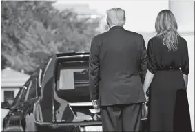  ?? EVAN VUCCI/AP PHOTO ?? President Donald Trump and first lady Melania Trump hold hands after the casket of Robert Trump was loaded into the hearse after a memorial service for the president’s younger brother at the White House on Friday in Washington.