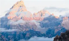  ?? KAREN BLEIER/GETTY-AFP2012 ?? The sun hits the tips of the Grand Tetons in Grand Teton National Park.