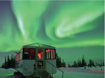  ?? Lindblad Expedition­s ?? Northern lights dance over an aurora pod in Churchill, Canada, a popular location