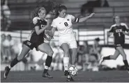  ??  ?? Notre Dame’s Liza Davini tries to maintain possession of the ball as Chattanoog­a Christian’s Olivia Hoffman applies defensive pressure during Thursday night’s game. Hoffman and Laura Beth Turner scored for the visiting Lady Chargers.