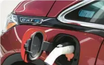  ?? JUSTIN SULLIVAN/GETTY ?? A Chevrolet Bolt EV sits parked at a charging station at Stewart Chevrolet on April 25 in Colma, California. Chevrolet announced plans to phase out production of its Chevrolet Bolt as the company paves the way for a new generation of electric vehicles.