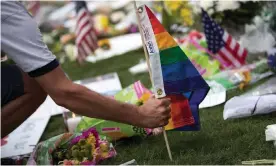  ?? Photograph: Drew Angerer/Getty Images ?? A Pride flag is planted at a makeshift memorial for victims of the Pulse shooting in Orlando, Florida, in June 2016.