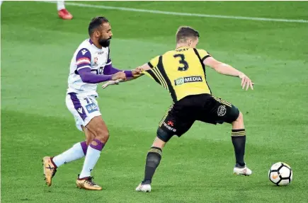  ?? GETTY IMAGES ?? Perth striker Diego Castro holds onto Phoenix defender Scott Galloway last night.