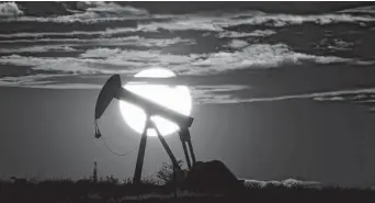  ?? Eric Gay / Associated Press ?? The sun sets behind an idle pump jack in the Permian basin. The OPEC+ alliance has been opening the taps only gradually to restore cuts made during the worst of the pandemic recession.