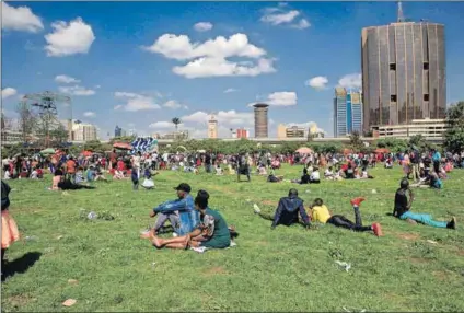  ?? Photo: Donwilson Odhiambo/getty Images ?? Exclusive: Kenyans gather at Uhuru Park on Christmas Day. But the park’s gates are closed and people now have to show identity documents to enter.