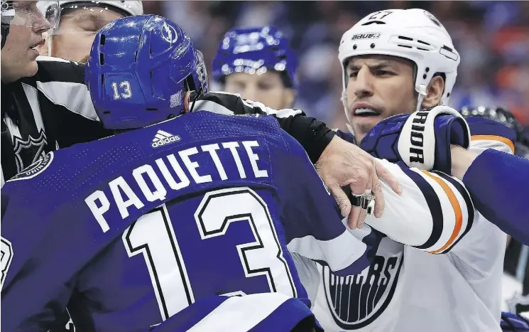  ?? MIKE EHRMANN/GETTY IMAGES ?? Tampa Bay’s Cedric Paquette and Edmonton’s Milan Lucic exchange pleasantri­es during a contentiou­s game at Amalie Arena on Tuesday in Tampa, Fla.