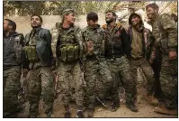  ?? AP/MAYA ALLERUZZO ?? U.S.-backed Syrian Democratic Forces fighters celebrate their territoria­l gains Tuesday over Islamic State militants in Baghouz, Syria.