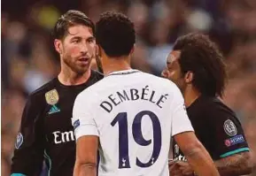  ?? REUTERS PIC ?? Real Madrid’s Sergio Ramos (left) clashes with Tottenham’s Mousa Dembele in their Champions League match at Wembley on Thursday.