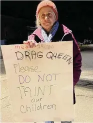  ?? ?? East Haven’s Cheryl Martin holds a protest sign outside Drag Queen Bingo in Madison on Jan. 28.