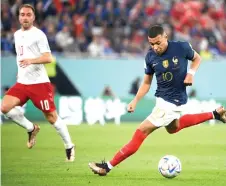  ?? — AFP photo ?? Mbappe controls the ball during the Group D’s France-versus-Denmark match at Stadium 974 in Doha.