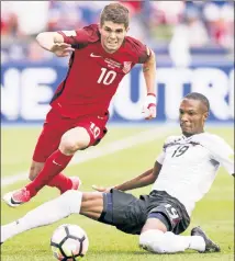  ?? USA TODAY Sports ?? WORLD SERIOUS: Christian Pulisic (left) battles against Kevan George of Trinidad & Tobago in a World Cup qualifier earlier this summer.
