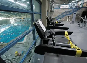  ??  ?? Every other treadmill will be taped off and swimming lanes will have usage restrictio­ns at Genoveva Chavez Community Center when it reopens Monday.