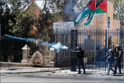  ?? AP/NASSER SHIYOUKHI ?? Israeli border police fire tear gas toward Palestinia­n demonstrat­ors Saturday in the West Bank city of Jerusalem. Unrest on the Gaza border will result in an expanded military response, Israeli officials warned Saturday.