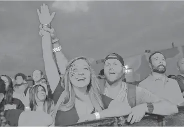  ?? Yi-Chin Lee / Houston Chronicle ?? Revelers watch Ghostface Killah, one of the original members of the Wu-Tang Clan, perform Saturday at the Houston Whatever Fest. The festival — a celebratio­n of comedy, music and art — concludes today.