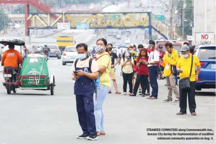  ??  ?? STRANDED COMMUTERS along Commonweal­th Ave., Quezon City during the implementa­tion of modified enhanced community quarantine on Aug. 4.