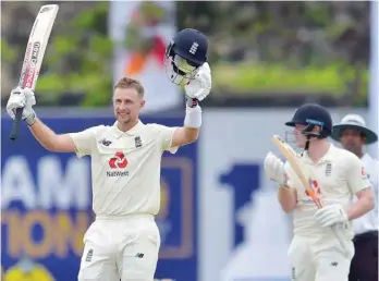  ??  ?? England captain Joe Root celebrates his double century in the first innings.