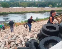  ?? Naugatuck River Revival Group / Contribute­d photo ?? A weekend cleanup of the Naugatuck River flowing under Ansonia’s River Walk dredged up a lot more than a few tires, rusted shopping carts and garbage.