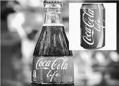  ??  ?? Distinctiv­e green packaging of new Cola revealed and it contains a third less sugar than the red tinned variety.