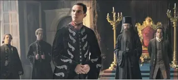  ??  ?? NICHOLAS HOULT, center, plays the toxic Emperor Peter III of Russia in the sumptuous historical comedy.