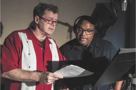  ?? WAHSINGTON POST PHOTO ?? Voice actor and instructor Johnny Heller, left, offers recommenda­tions to voice actor David Sadzin during a recording session at Edge Studio in New York.