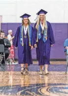  ?? NEWS GROUP ?? Valedictor­ians Haley Hatzinger (left) and Rachel Mason lead the procession­al into the gym during the Class of 2019 Commenceme­nt Ceremony at Palmyra-Eagle High School on June 2, 2019.