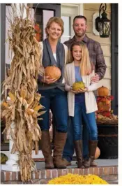  ??  ?? Julie, Andy and Olivia look for the perfect spot to tuck in just a few more fall touches.