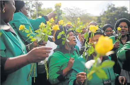  ?? Picture: ALAISTER RUSSELL/THE SUNDAY TIMES ?? FITTING TRIBUTE: Members of the ANC Women’s League hand out flowers ahead of their march through the streets of Orlando, Soweto, to lay at the family home of struggle stalwart Winnie Madikizela-Mandela