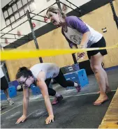  ?? MATT OLSON ?? Bruce Gordon’s daughter Jillian Bodnar, left, competes in the Be Like Bruce Fitness Festival to honour his memory while Bruce’s wife, Chris Gordon, right, acts as a judge at the Reebok Crossfit 306 gym on Saturday.