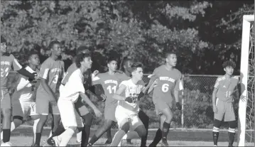  ?? STAFF PHOTO BY JOHN NISWANDER ?? Players from St. Charles and Westlake get ready for an incoming corner kick in front of the Wolverines goalkeeper Levell Kenny. St. Charles topped Westlake on its senior day Wednesday, 3-1.