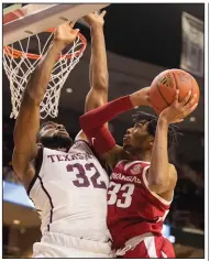  ?? (AP/College Station Eagle/Michael Miller) ?? Arkansas’ Jimmy Whitt (right) tries to put up a shot against Texas A&M’s Josh Nebo on Saturday during the Razorbacks’ 77-69 loss to the Aggies in College Station, Texas.
