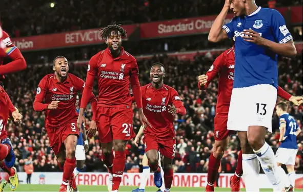  ??  ?? Perfect timing: Liverpool forward Divock Origi (second from left) celebratin­g after scoring his side’s winning goal against Everton during the Premier League match at Anfield on Sunday. Below: Everton goalkeeper Jordan Pickford. — AP/Reuters
