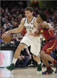  ?? TONY DEJAK - THE ASSOCIATED PRESS ?? Milwaukee Bucks’ Brook Lopez (11) drives past Cleveland Cavaliers’ Collin Sexton (2) during the first half of an NBA basketball game Wednesday, March 20, 2019, in Cleveland.