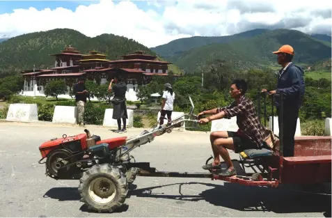  ??  ?? A tourists taking pictures at the historic Punakha Dzong administra­tive centre, a prominent tourist attraction in Punakha.