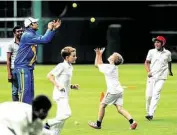  ??  ?? Former Indian cricketer VVS Laxman tosses balls with youths from the top area cricket academies during a clinic at Minute Maid Park.