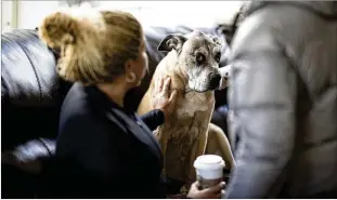  ?? MARVIN JOSEPH/WASHINGTON POST ?? Lap of Love offers vet referrals for pet owners such as Eden Gaines, who recently said goodbye to Xochi, her 11-year-old boxer-Great Dane mix, from the comfort of home. Xochi had cancer and was euthanized while surrounded by family members.