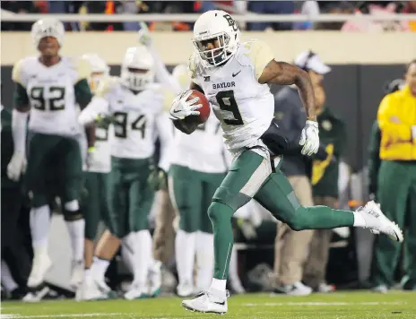  ?? TOM PENNINGTON/GETTY IMAGES ?? Speedy receiver K.D. Cannon, shown scoring a touchdown for the Baylor Bears in 2015, has quickly made a positive impression with the Saskatchew­an Roughrider­s. He signed with the CFL team in September after he was released from the NFL’S Dallas Cowboys.