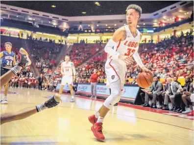  ?? ROBERTO E. ROSALES/JOURNAL ?? UNM’s Anthony Mathis looks for an open teammate under the basket during Saturday night’s game in the Pit. Mathis finished with 25 points and went 5 for 5 from 3-point range as the Lobos rolled to an exhibition win over Northern New Mexico.