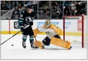  ?? TONY AVELAR- THE ASSOCI ATED PRESS ?? Nashville Predators goaltender Juuse Saros (74) blocks a shot by San Jose Sharks left w ing Fabian Zetterlund (20) during the first period Saturday in San Jose.