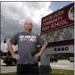 ?? JIM RASSOL THE ASSOCIATED PRESS ?? Santaluces High School teacher Michael Woods stands in front of his school sign in Lantana, Fla., wearing his protest shirt “We Are All Human” in opposition to recent book bans by Florida Gov. Ron DeSantis this week.