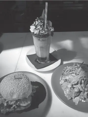  ?? Photo for The Washington Post by Ceil Miller-Bouchet ?? ■ A bourbon milkshake, fried green tomato hamburger and fried green tomato salad at Whiskey Dry.