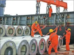  ?? WANG BICHUN / FOR CHINA DAILY ?? Workers hoist steel coils for export to the Philippine­s at Yangkou Port in Jiangsu province.