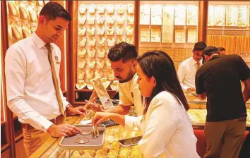  ?? Virendra Saklani/Gulf News ?? Forecasts among UAE jewellery retailers suggest that prices upwards of $2,000 will persist in the near future, prompting shoppers to reconsider their approach to gold buying.