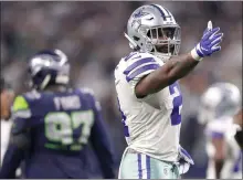  ??  ?? Ezekiel Elliott of the Dallas Cowboys gestures for a first down against the Seattle Seahawks during the Wild Card Round at AT&T Stadium in January in Arlington, Texas. [TOM PENNINGTON/GETTY IMAGES. TNS]