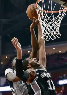  ?? —AP ?? Spurs forward LaMarcus Aldridge (right) shoots as Rockets center Clint Capela defends during second-half Game6 action.