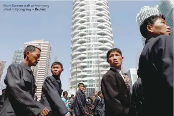  ?? — Reuters ?? North Koreans walk at Ryomyong street in Pyongyang.