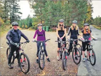  ??  ?? Lucy, Joley, Ellie and Kirstie enjoy a cycle with their instructor in the forest near Aviemore.