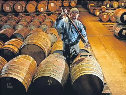  ?? Picture: Getty. ?? A whisky sample is taken from a cask at Bruichladd­ich in Islay.