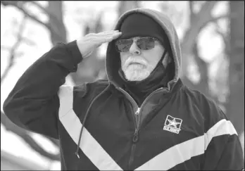  ?? Staff photo/ Jake Dowling ?? Ralph Reynolds, chairman of Freedom’s Colors, salutes as a wreath is placed at Clifford Hammond’s headstone Saturday afternoon at Elm Grove Cemetery. Reynolds and his wife traveled to five counties and around 160 miles on Saturday to lay wreaths at the graves of 27 Auglaize County natives who were killed in action in various wars.